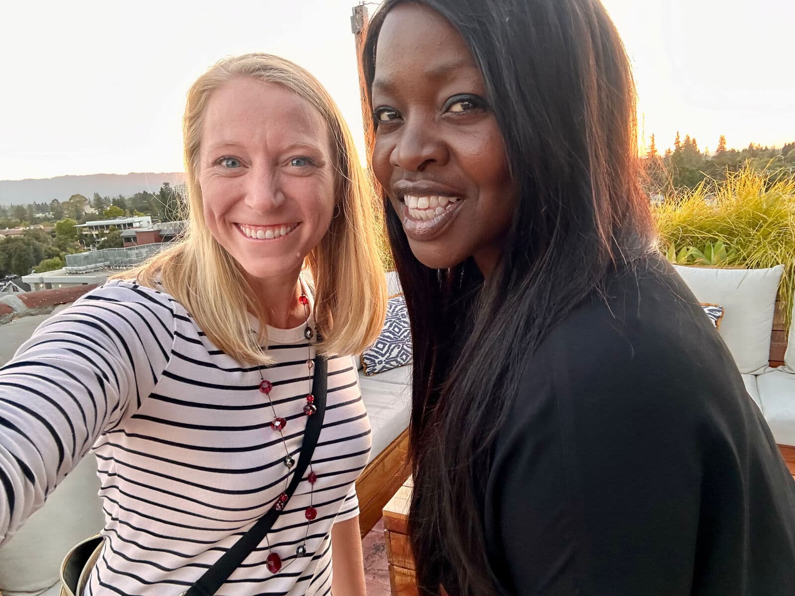 MatchUP co-founders Catt and Katie together on a rooftop at golden hour